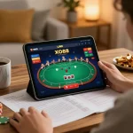 Engaging with LINK XO88 online casino on a tablet, surrounded by cozy decor and strategic notes.